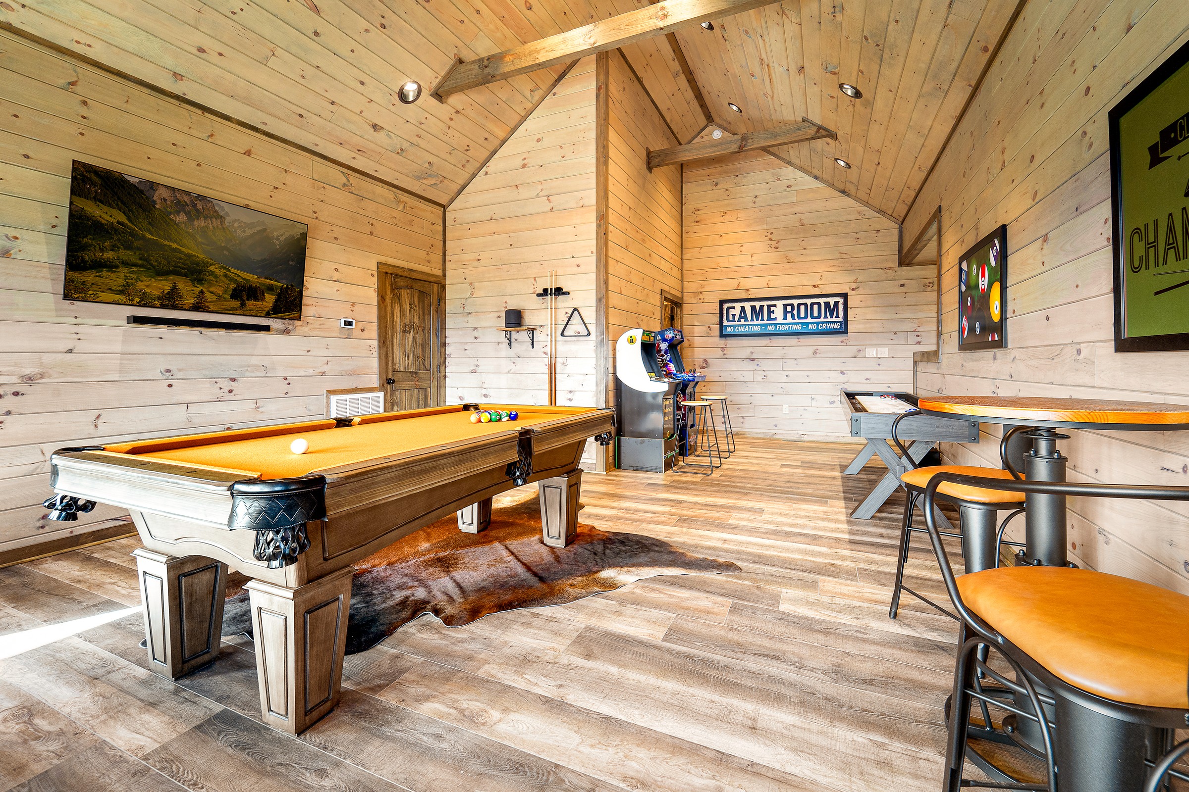 Game room with pool table, shuffleboard, unlimited play arcade games and mountain views