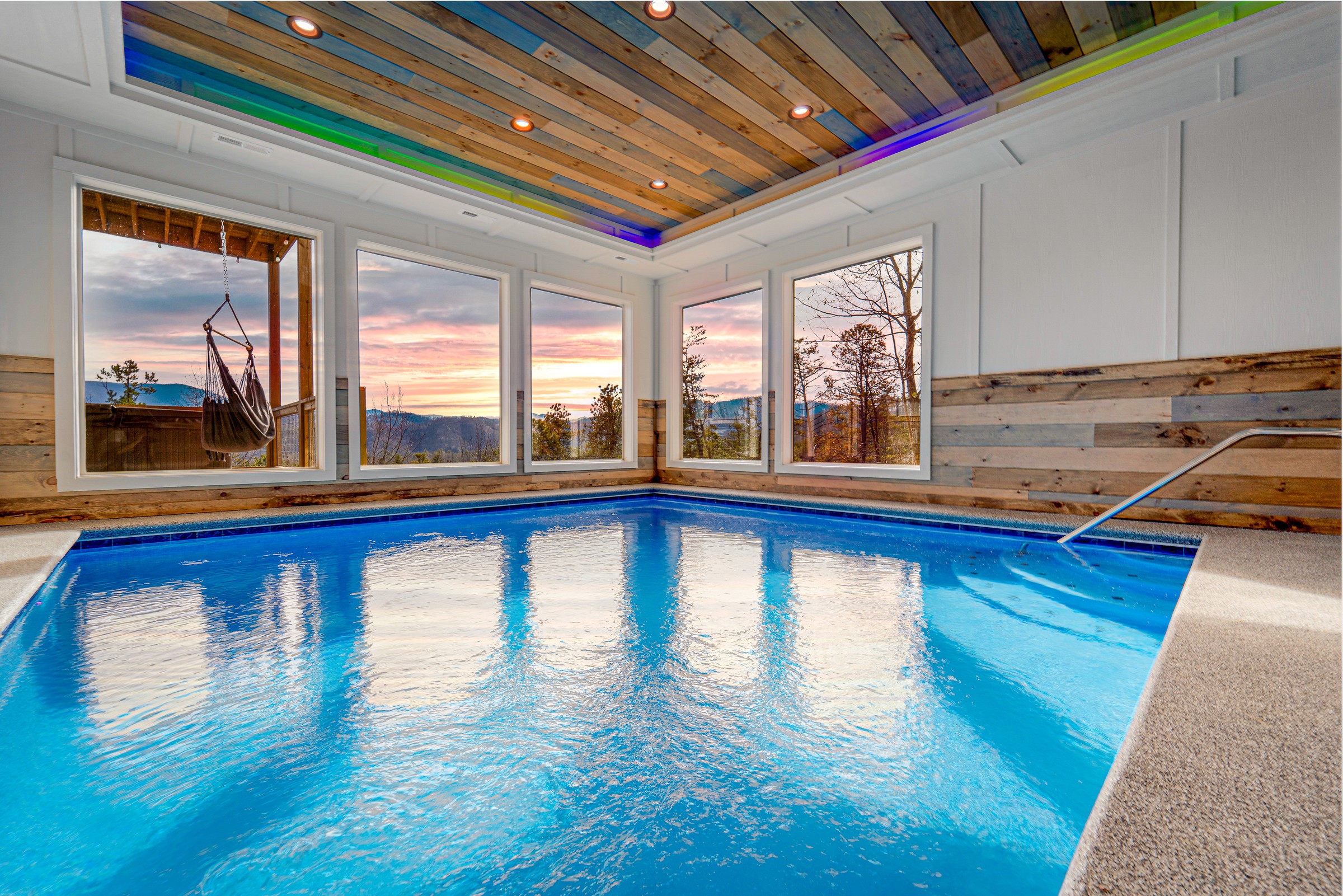 Heated indoor pool with LED ceiling and panoramic mountain sunset views