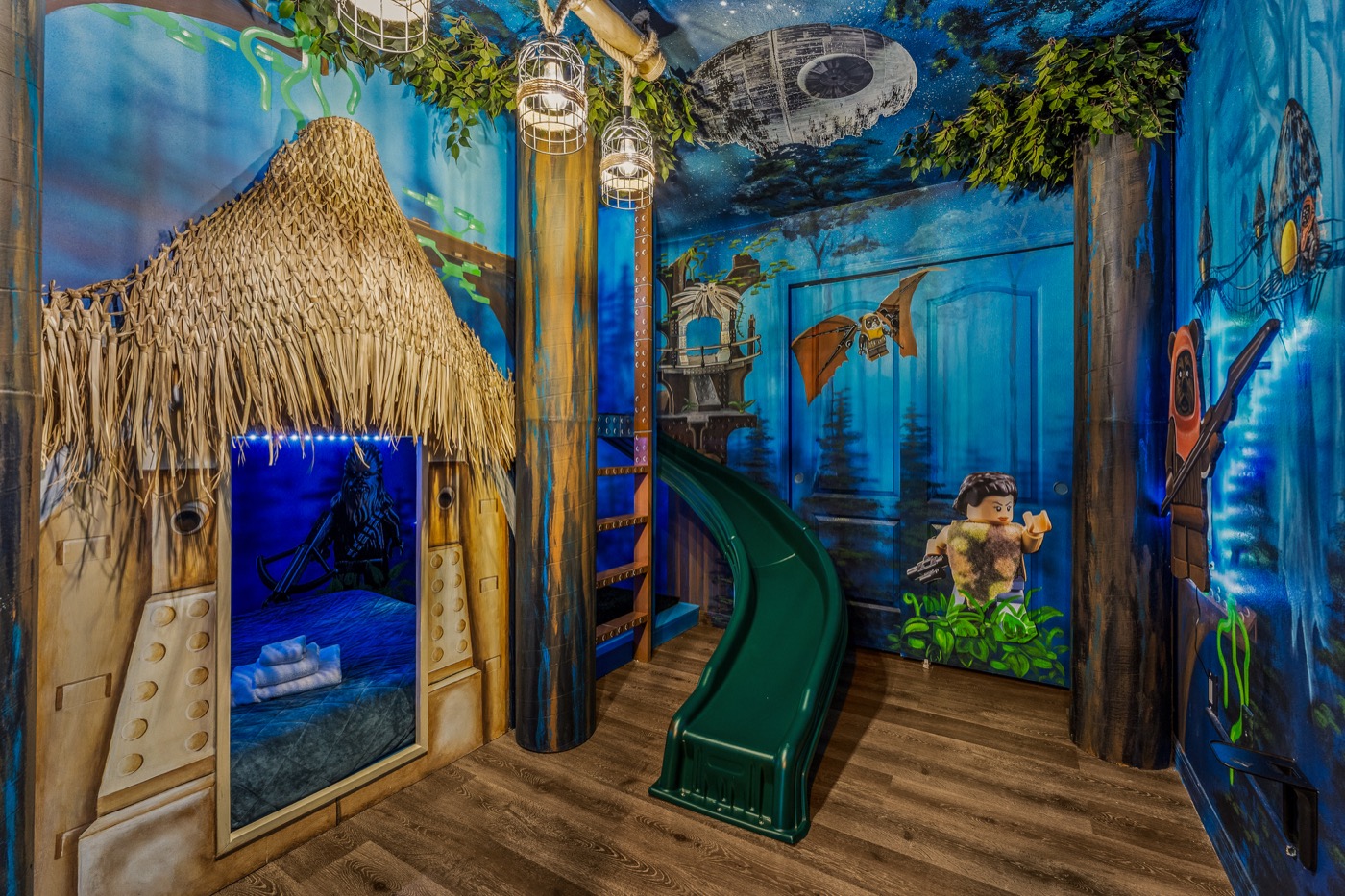 Star Wars Endor themed bunk room with Ewok hut bed, green slide and forest moon mural